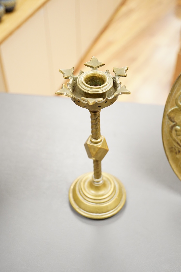 A pair of Pugin style ‘gothic’ brass candlesticks - 21cm high and a circular brass disc depicting Hercules and The Nemean Lion - 25cm in diameter